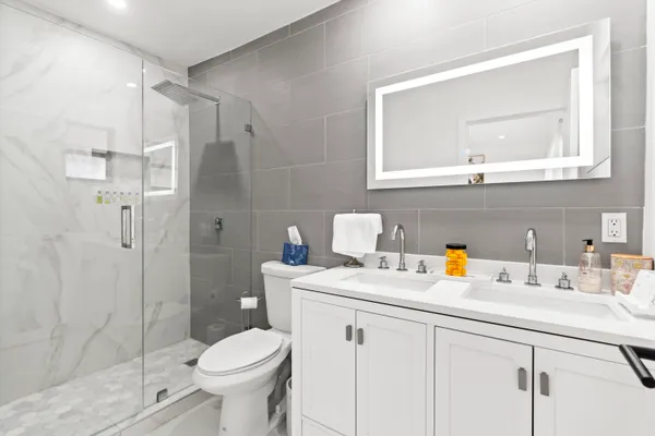 a bathroom with a sink toilet and shower