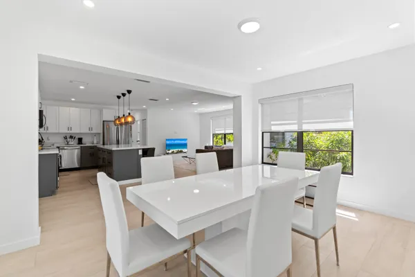 a view of a dining room with furniture and a kitchen