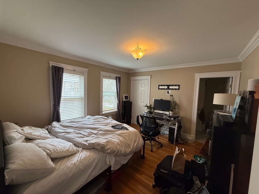 72 Bennett Street, Unit 72 Boston, MA 02135 - Photo 11 of 17 a bedroom with a bed and wooden floor