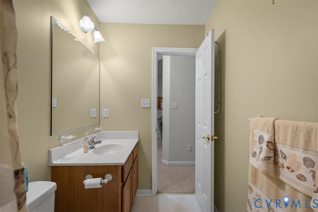 4319 Stately Oak Road North Chesterfield, VA 23234 - Photo 20 of 51 Wood-finish vanity with a white countertop and int