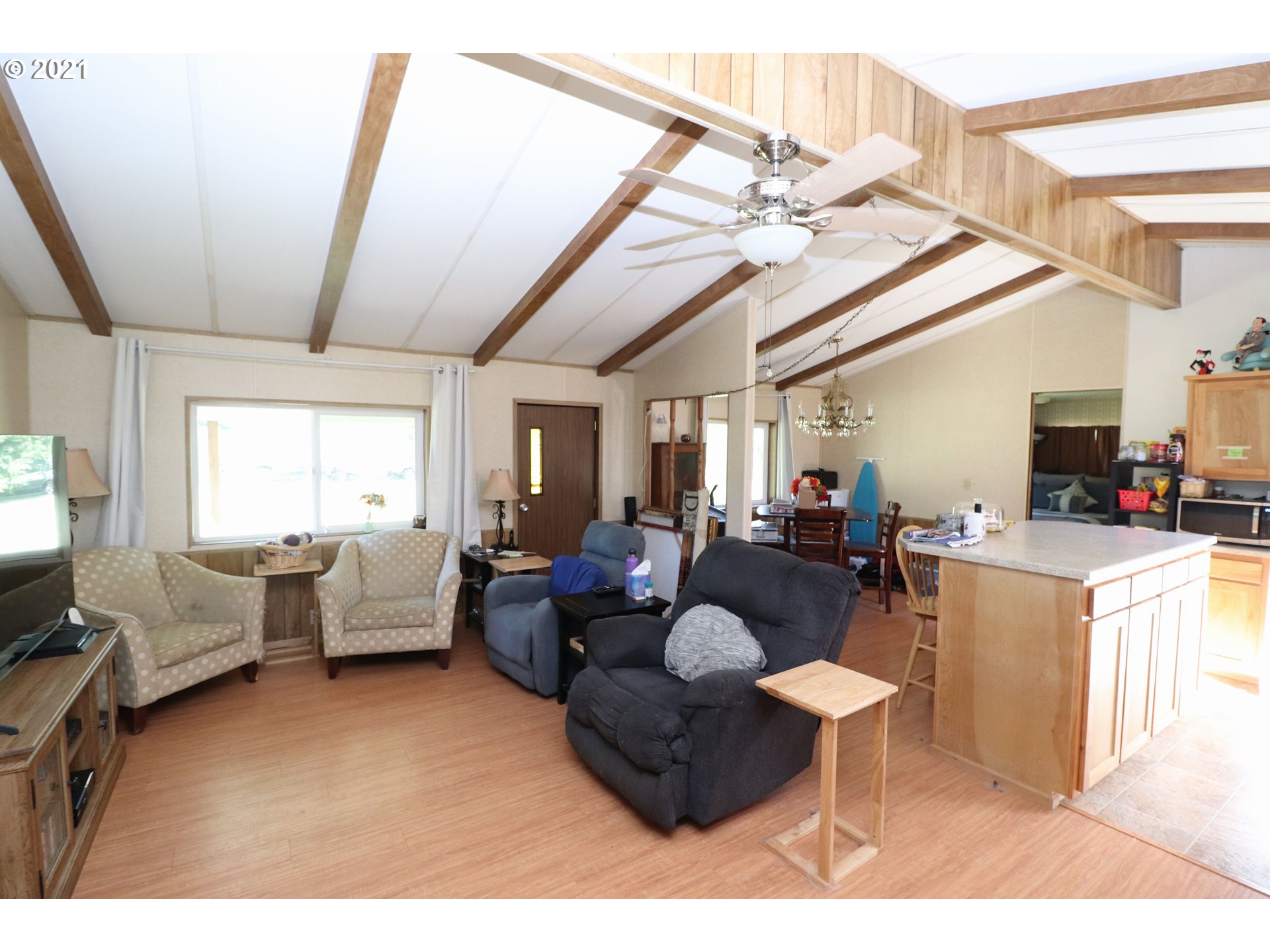 78471 Sears Road Cottage Grove, OR 97424 - Photo 11 of 31 a living room with furniture a flat screen tv and a window
