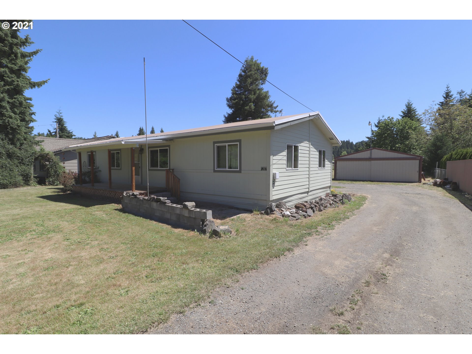 78471 Sears Road Cottage Grove, OR 97424 - Photo 2 of 31 a front view of a house with a yard and garage