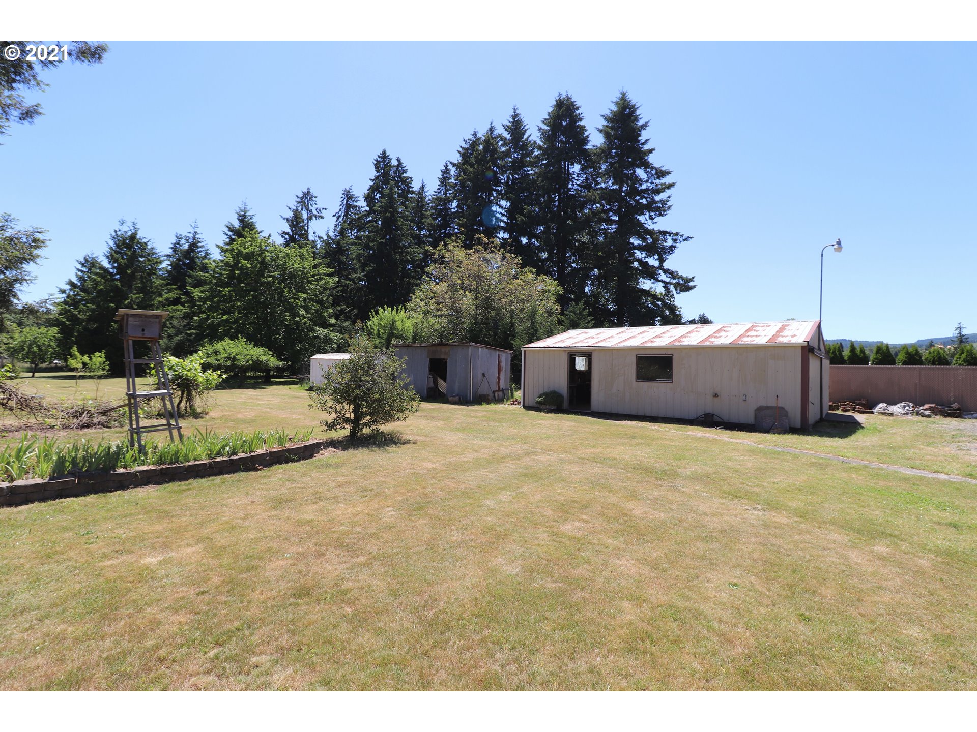 78471 Sears Road Cottage Grove, OR 97424 - Photo 24 of 31 a backyard of a house with table and chairs