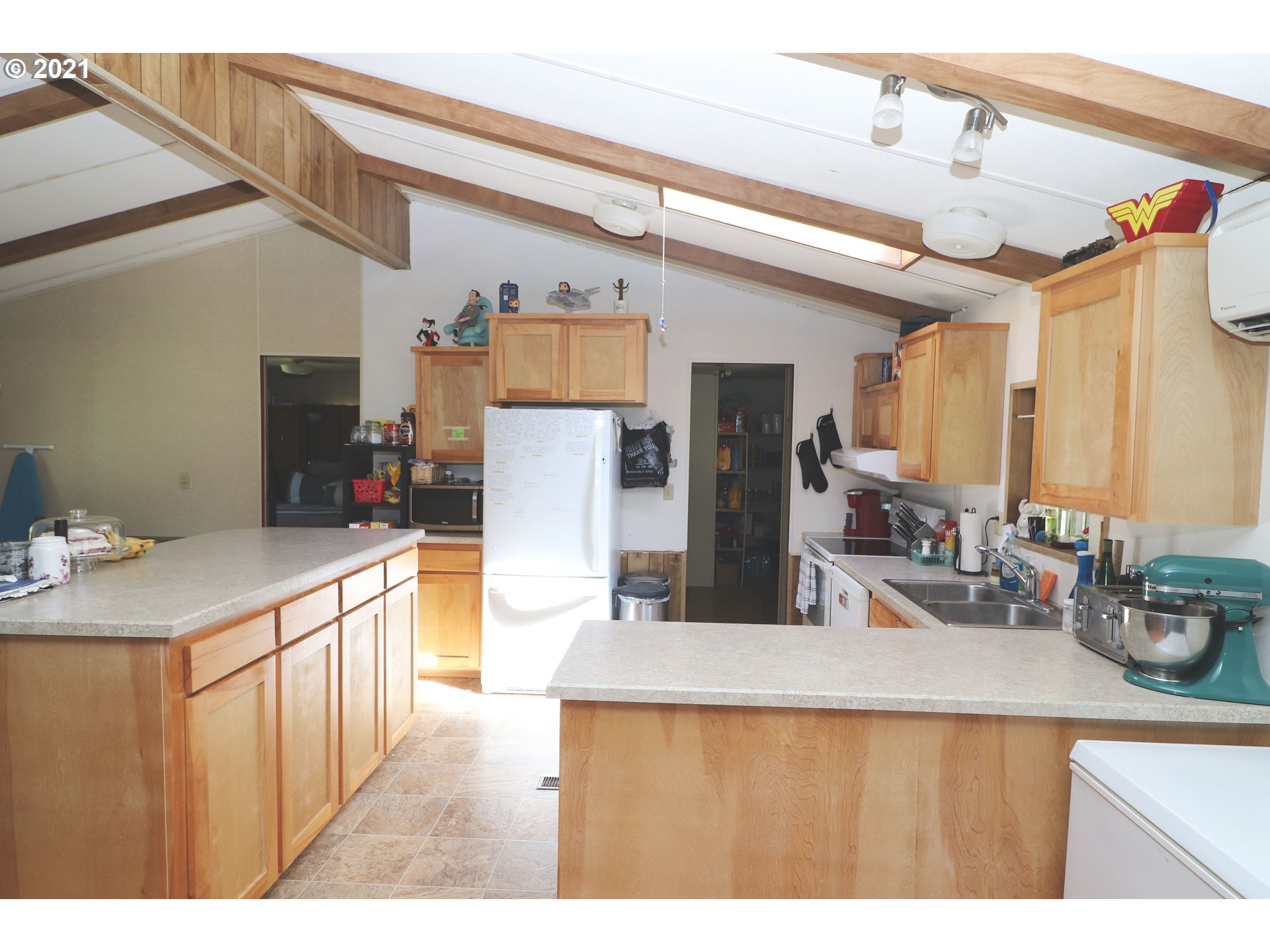 78471 Sears Road Cottage Grove, OR 97424 - Photo 6 of 31 a kitchen with stainless steel appliances kitchen island granite countertop a refrigerator and a sink