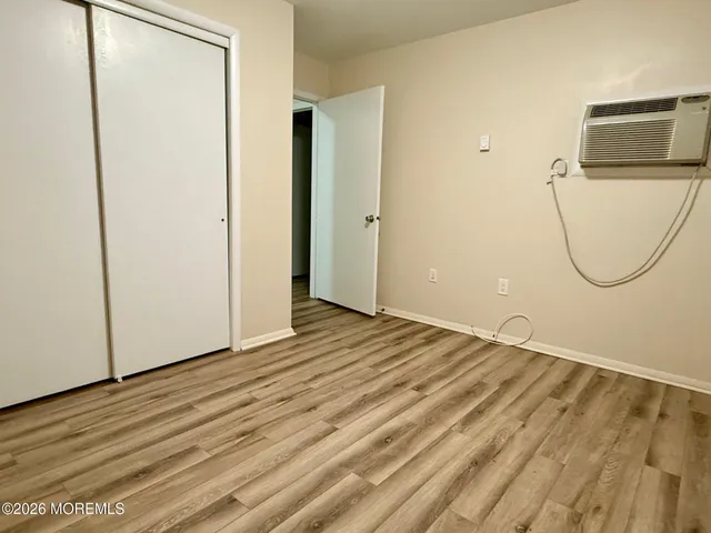a view of a room with wooden floor and white wall