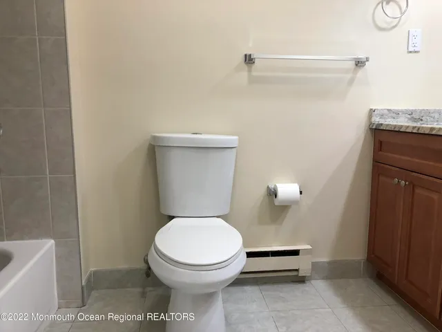 a white toilet sitting next to a bathroom sink