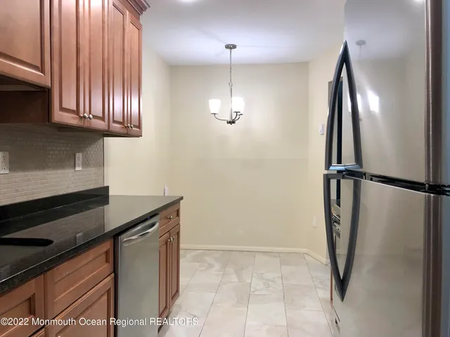 a kitchen with stainless steel appliances granite countertop a refrigerator and a sink