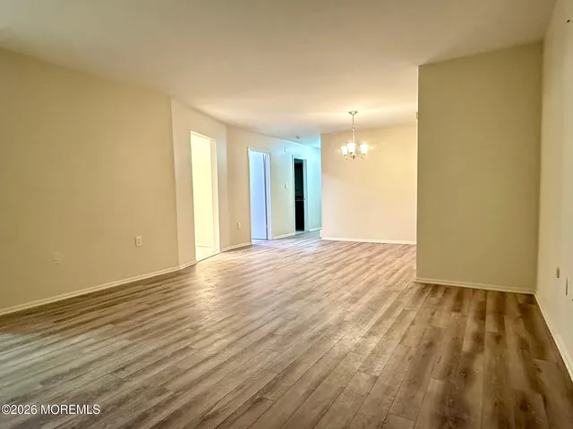 a view of an empty room and wooden floor