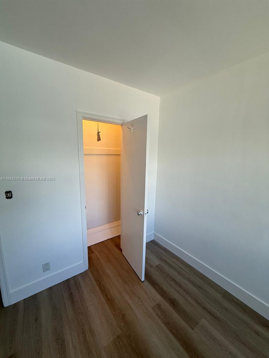 10074 East Bay Harbor Drive, Unit 74C Bay Harbor Islands, FL 33154 - Photo 13 of 28 an empty room with wooden floor and closet