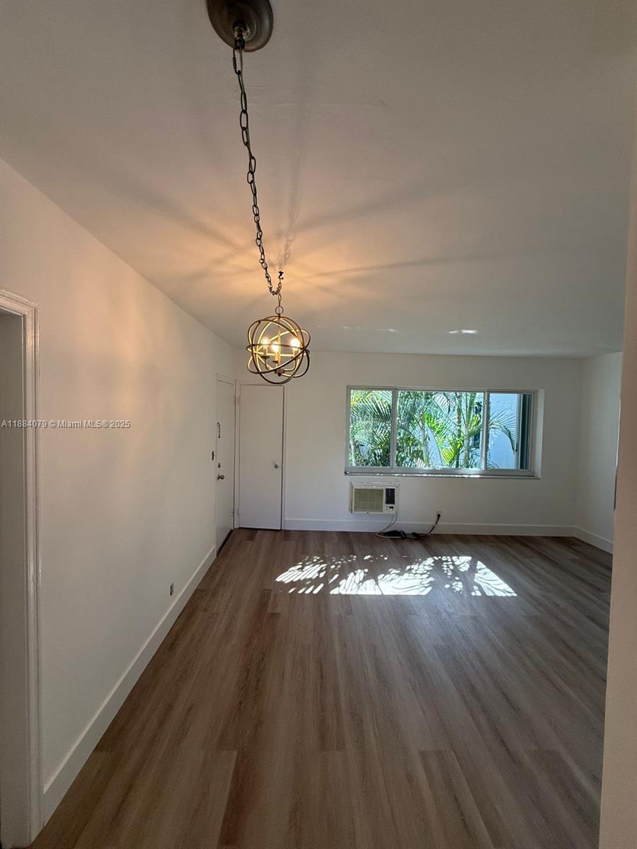 10074 East Bay Harbor Drive, Unit 74C Bay Harbor Islands, FL 33154 - Photo 2 of 28 a view of a room with wooden floor chandelier and window