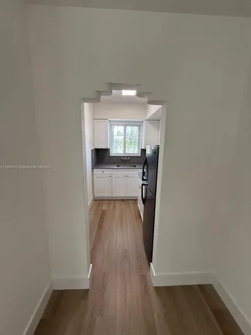 a kitchen with granite countertop a sink stove and cabinets