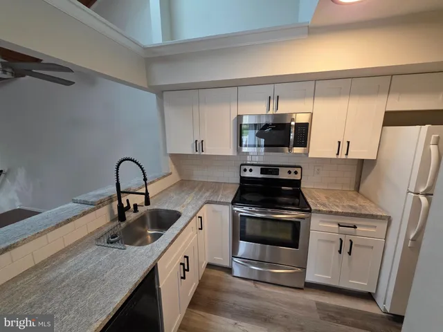 a kitchen with a stove microwave and refrigerator