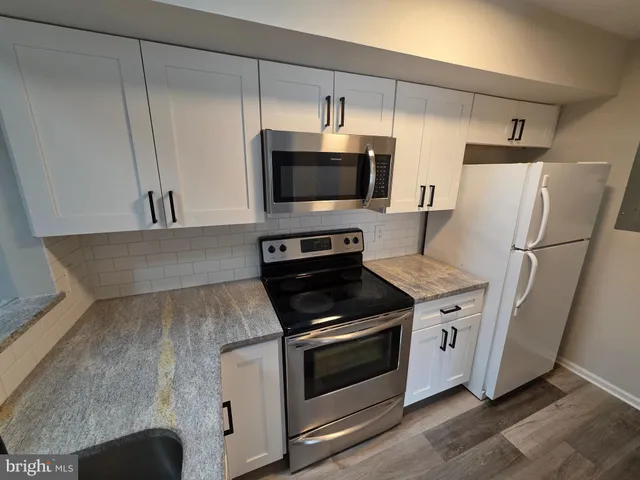a kitchen with a sink cabinets and stainless steel appliances