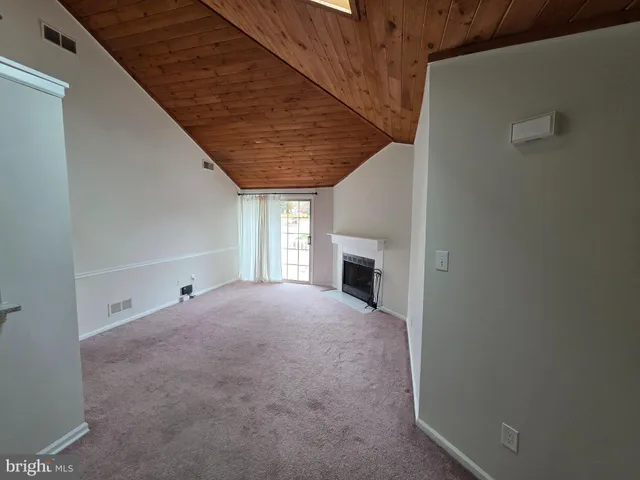 a view of empty room with a fireplace