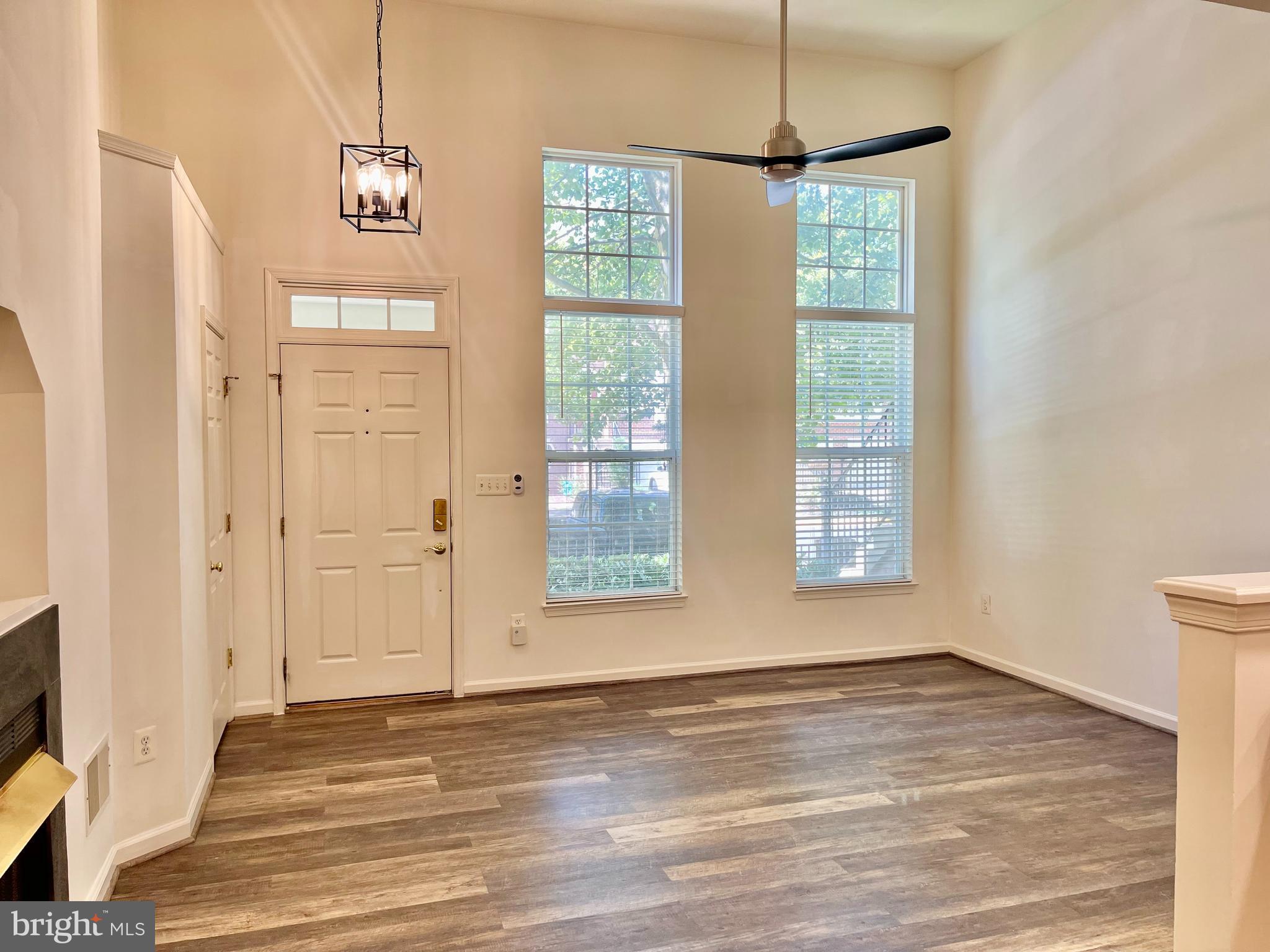 1883 Crescent Park Drive, Unit 112A Reston, VA 20190 - Photo 3 of 23 a view of an empty room with a window and hardwood floor