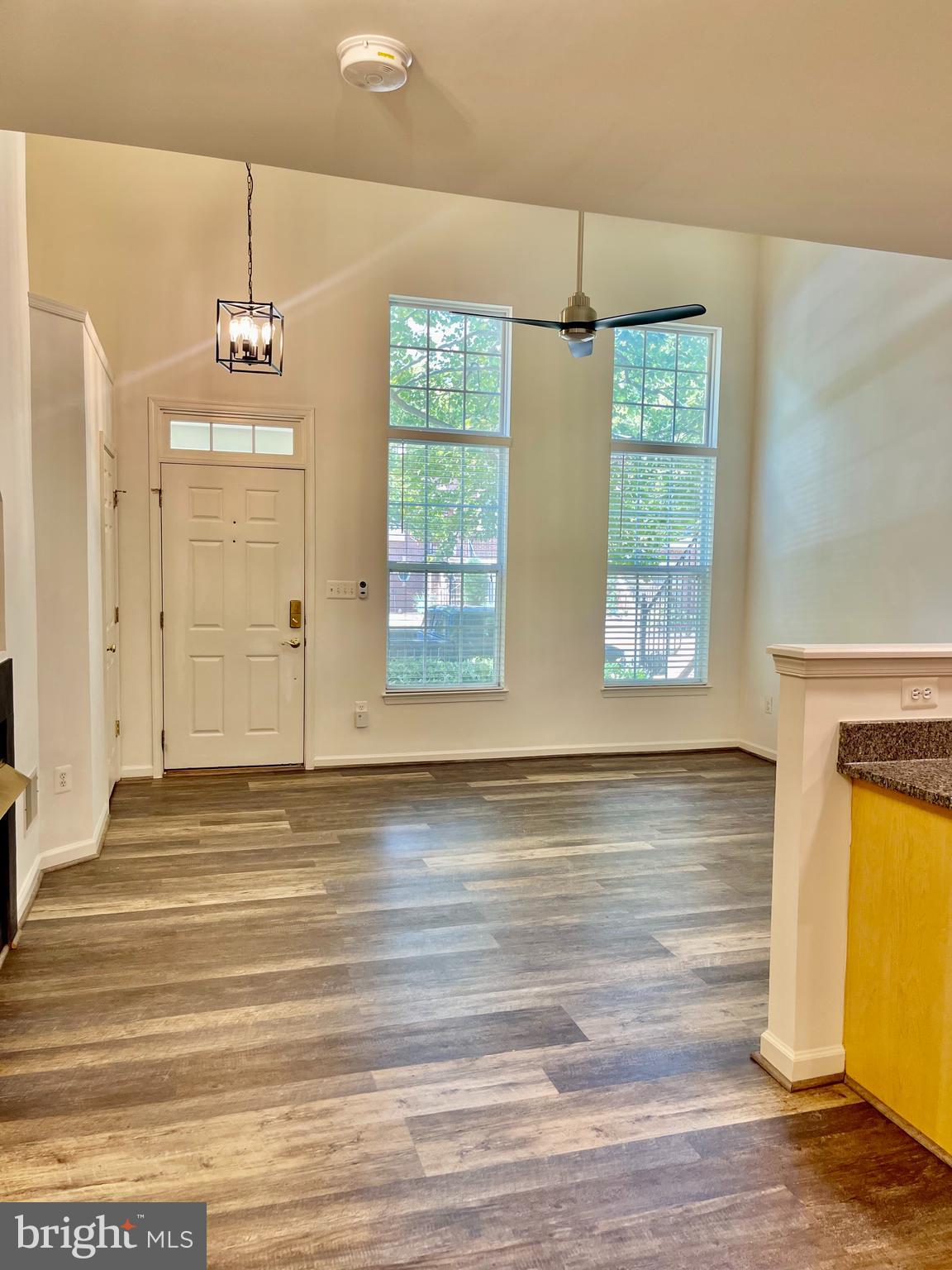 1883 Crescent Park Drive, Unit 112A Reston, VA 20190 - Photo 4 of 23 a view of a room with wooden floor and windows