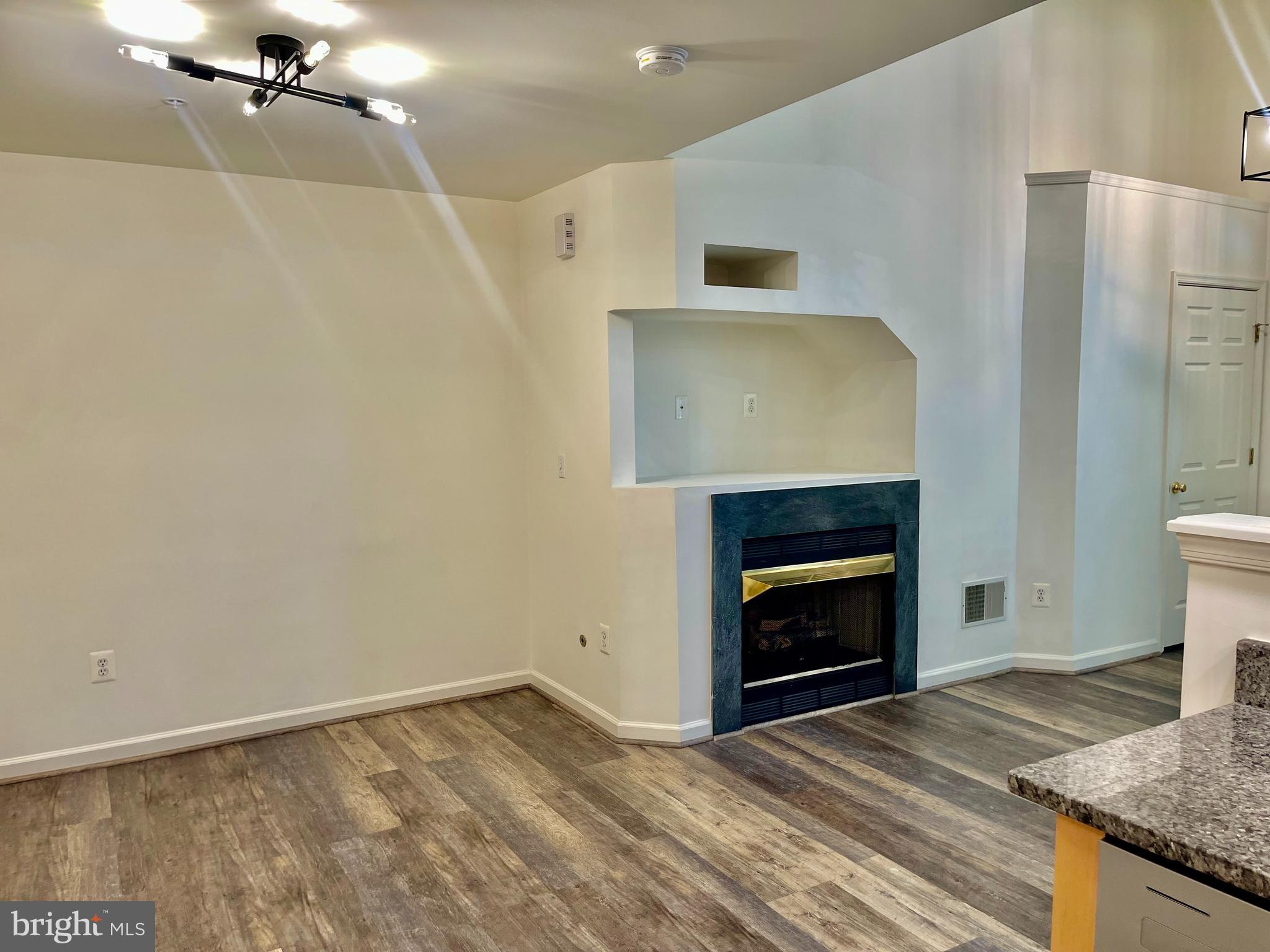 1883 Crescent Park Drive, Unit 112A Reston, VA 20190 - Photo 5 of 23 a view of an empty room with a fireplace and a window