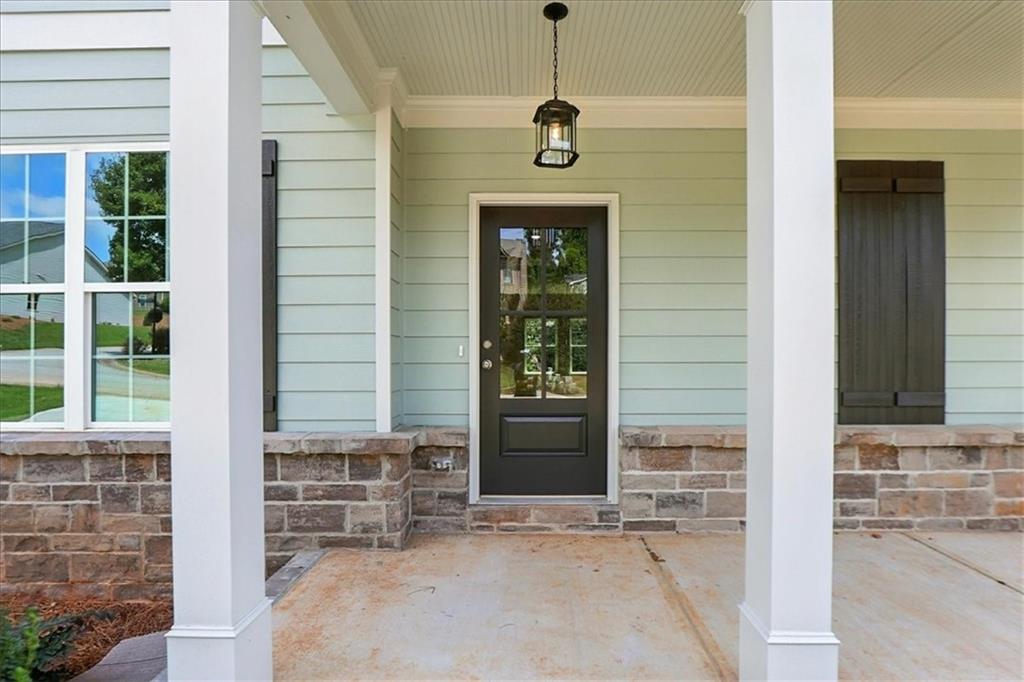 4034 Links Boulevard Jefferson, GA 30549 - Photo 2 of 68 a front view of a house with a yard and garage