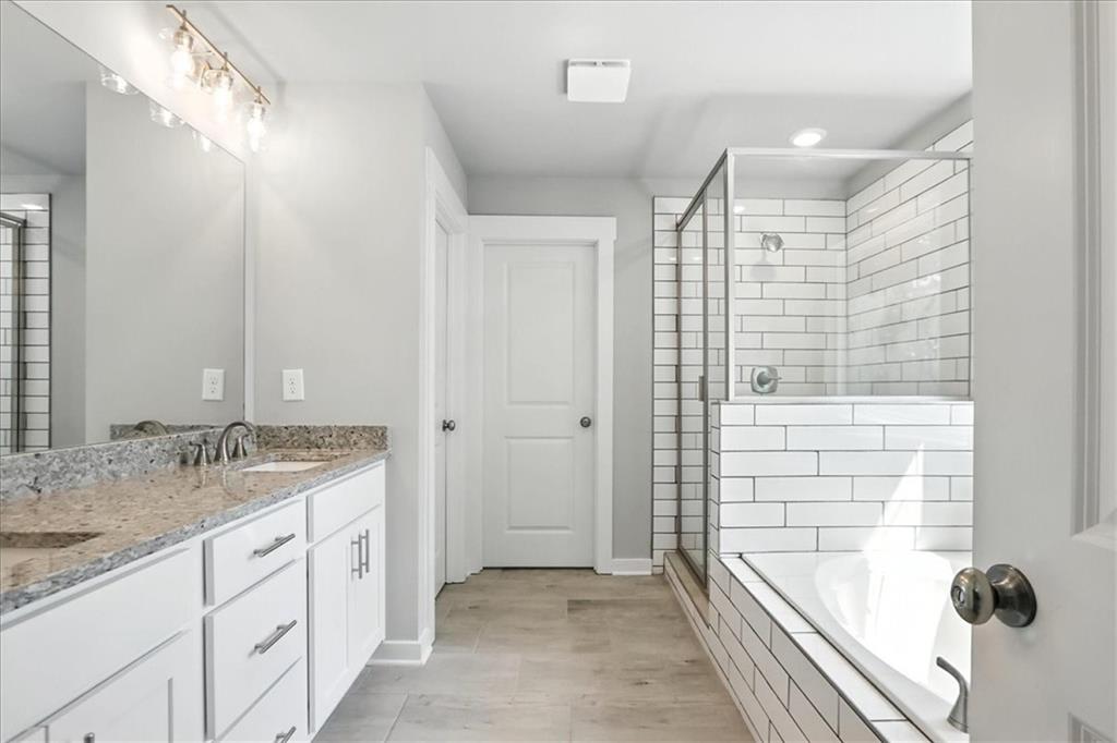 4034 Links Boulevard Jefferson, GA 30549 - Photo 30 of 68 a bathroom with a granite countertop sink and a shower