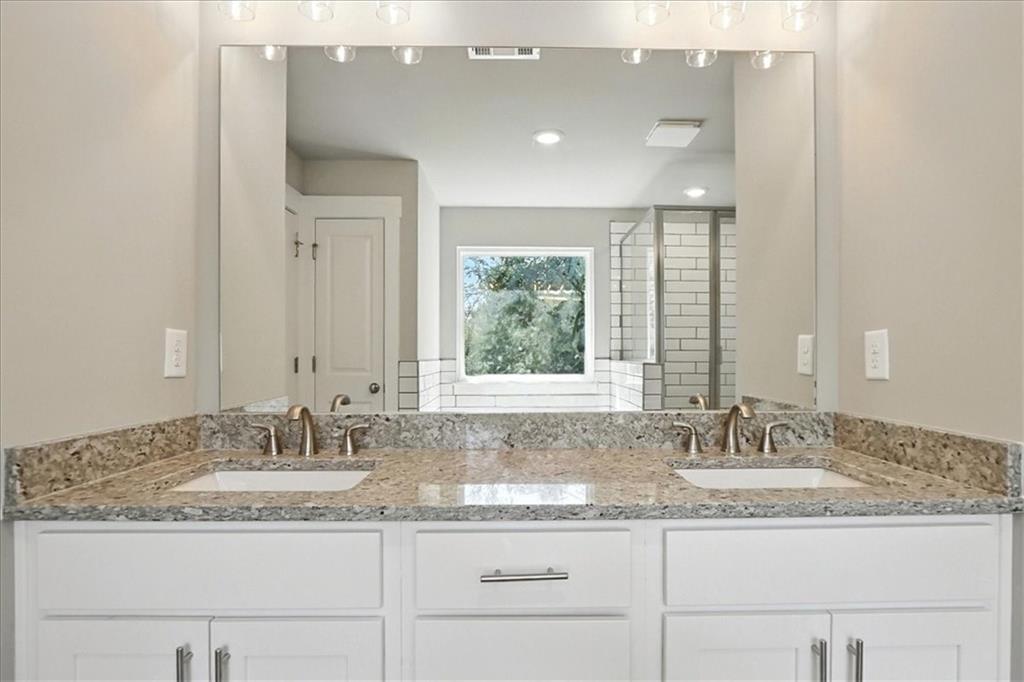4034 Links Boulevard Jefferson, GA 30549 - Photo 31 of 68 a bathroom with a granite countertop sink and a mirror