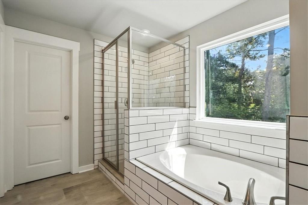 4034 Links Boulevard Jefferson, GA 30549 - Photo 33 of 68 a bathroom with a bathtub and a shower