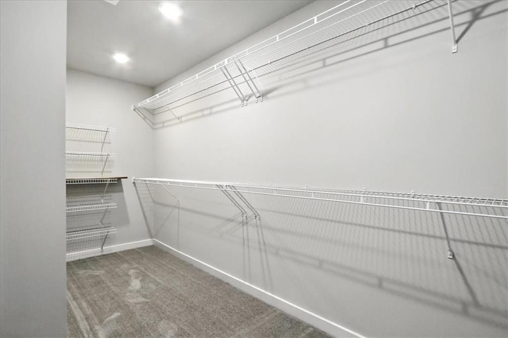 4034 Links Boulevard Jefferson, GA 30549 - Photo 35 of 68 a view of walk in closet with empty racks