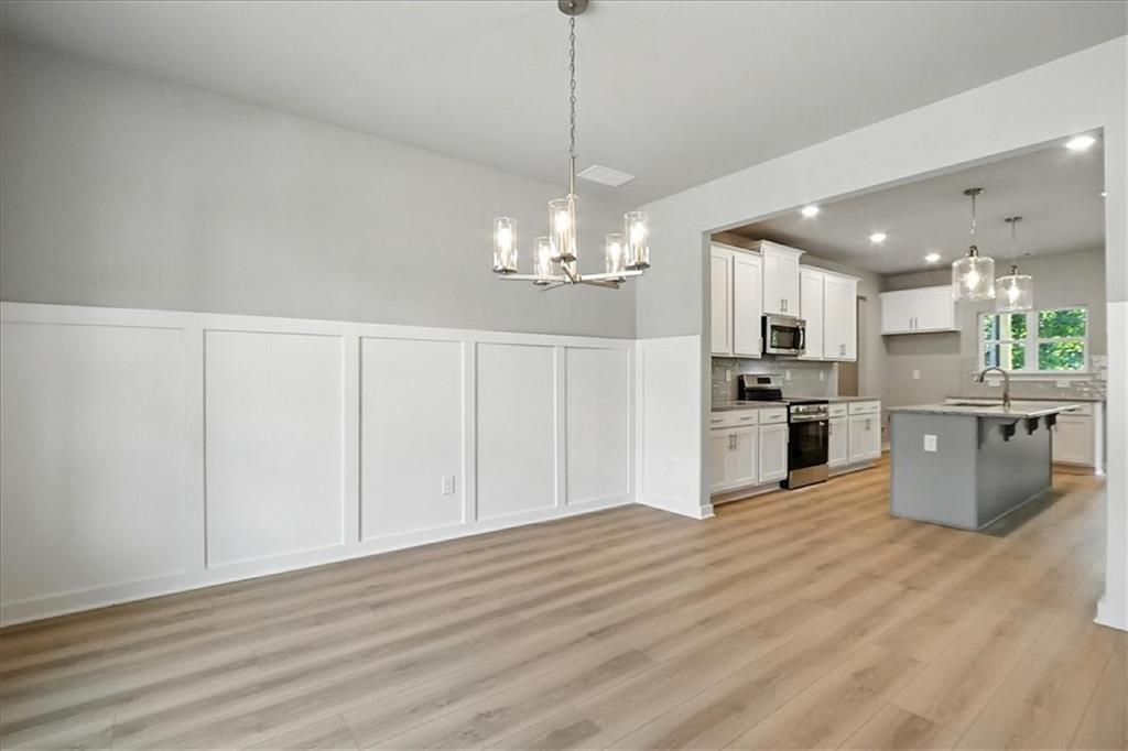 4034 Links Boulevard Jefferson, GA 30549 - Photo 6 of 68 a open kitchen with cabinets a sink and stainless steel appliances