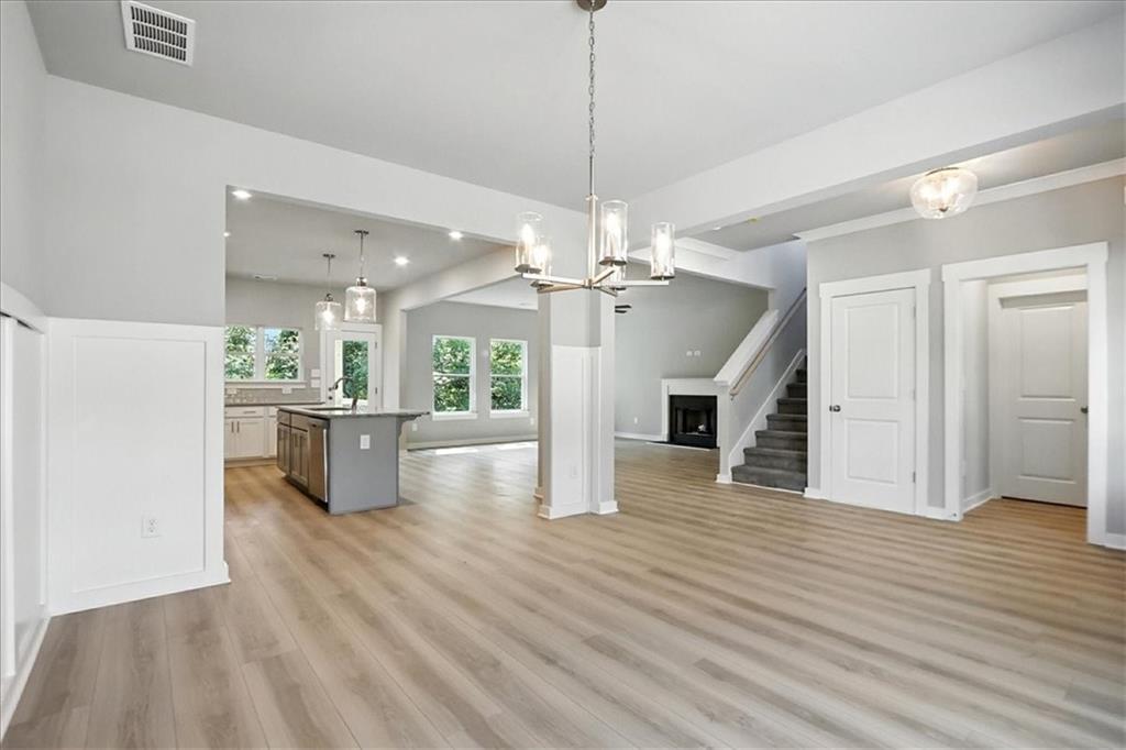 4034 Links Boulevard Jefferson, GA 30549 - Photo 7 of 68 a view of a kitchen with a kitchen island wooden floor stainless steel appliances and a ceiling fan