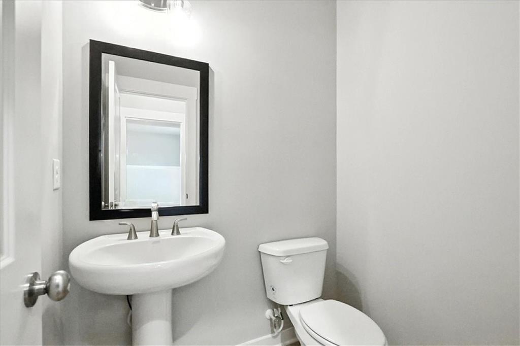 4034 Links Boulevard Jefferson, GA 30549 - Photo 10 of 68 a bathroom with a sink a toilet and mirror