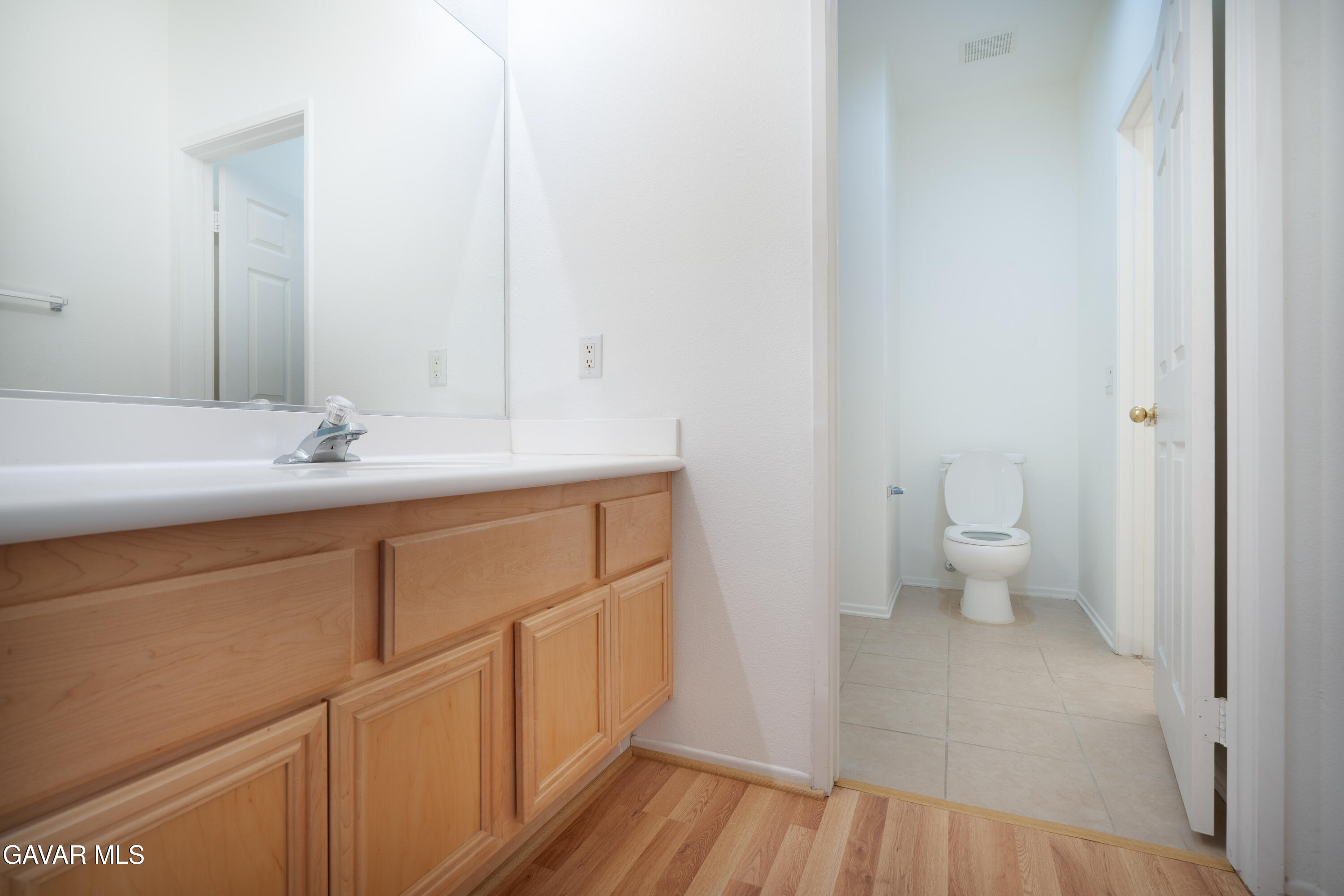 40263 Preston Road Palmdale, CA 93551 - Photo 11 of 24 a bathroom with a sink a toilet and a mirror