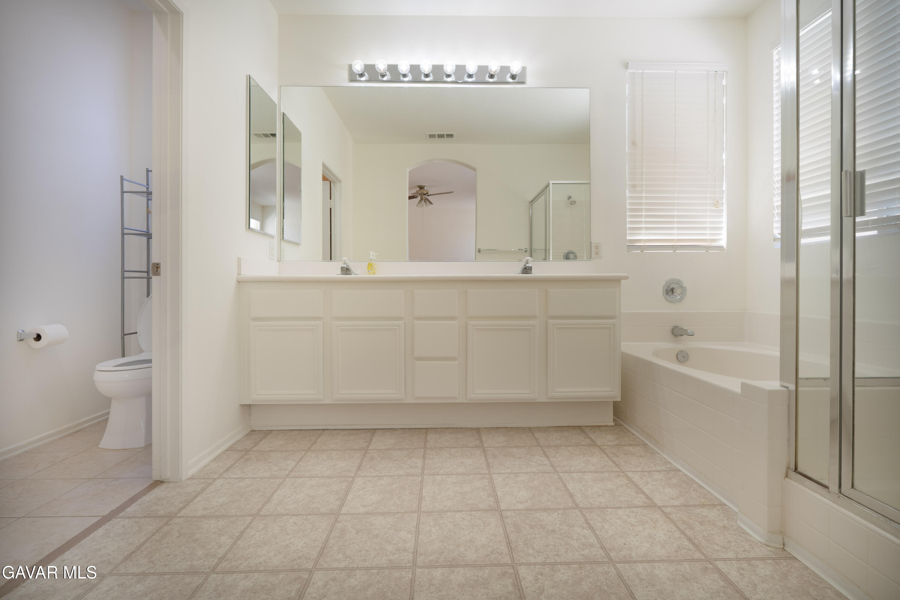 40263 Preston Road Palmdale, CA 93551 - Photo 12 of 24 a spacious bathroom with a mirror sink and a bathtub