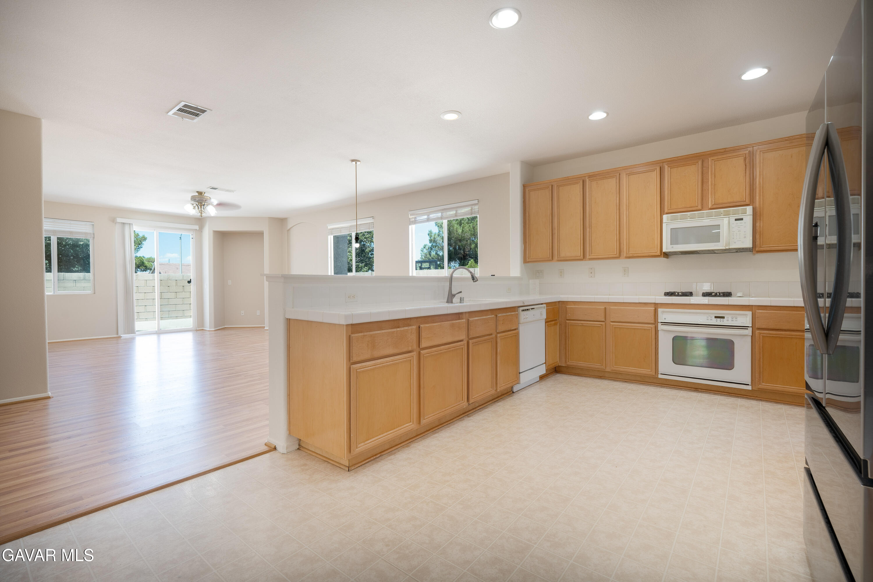 40263 Preston Road Palmdale, CA 93551 - Photo 22 of 24 a large kitchen with a stove top oven