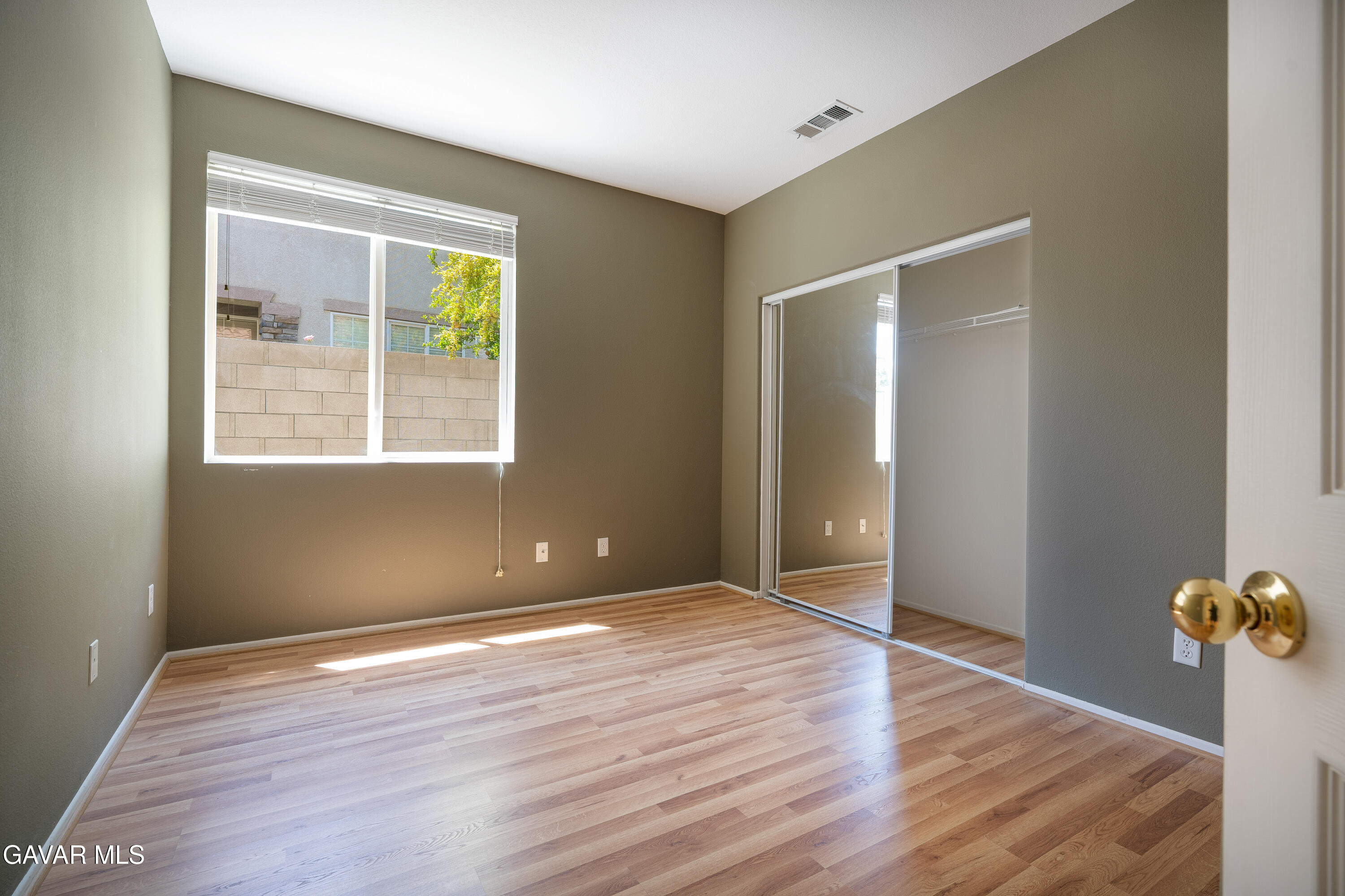 40263 Preston Road Palmdale, CA 93551 - Photo 9 of 24 a view of an empty room with wooden floor and a window