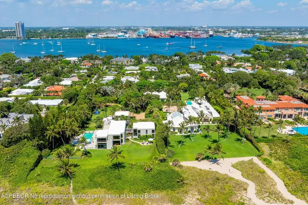 an aerial view of a house with a yard and lake view