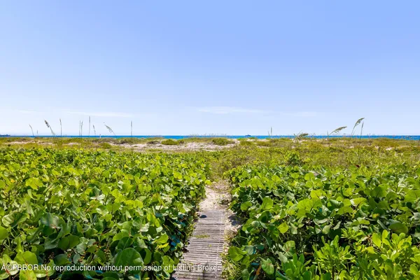 a front view of a house with a yard and a garage