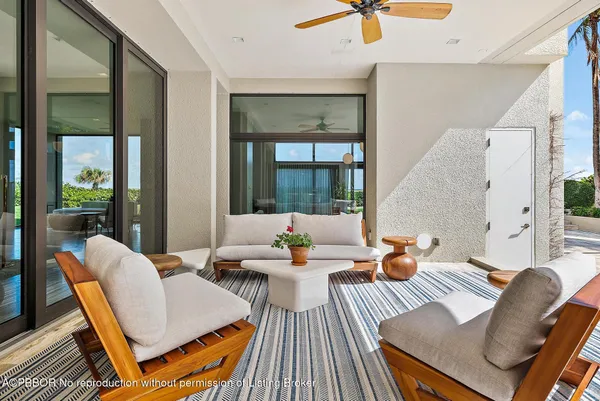 a living room with furniture a flat screen tv and a wall painting