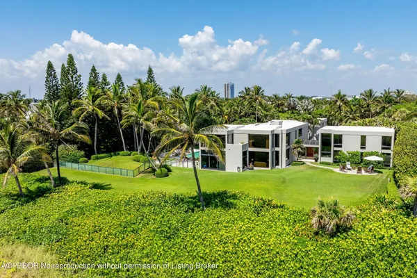 a view of a house with a big yard and large trees