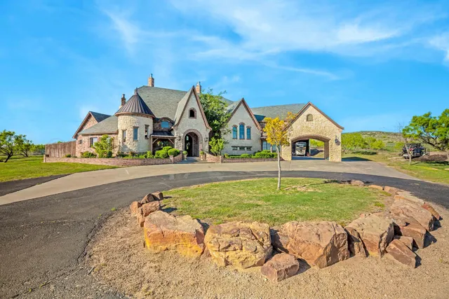 a view of swimming pool with outdoor seating and house in the background