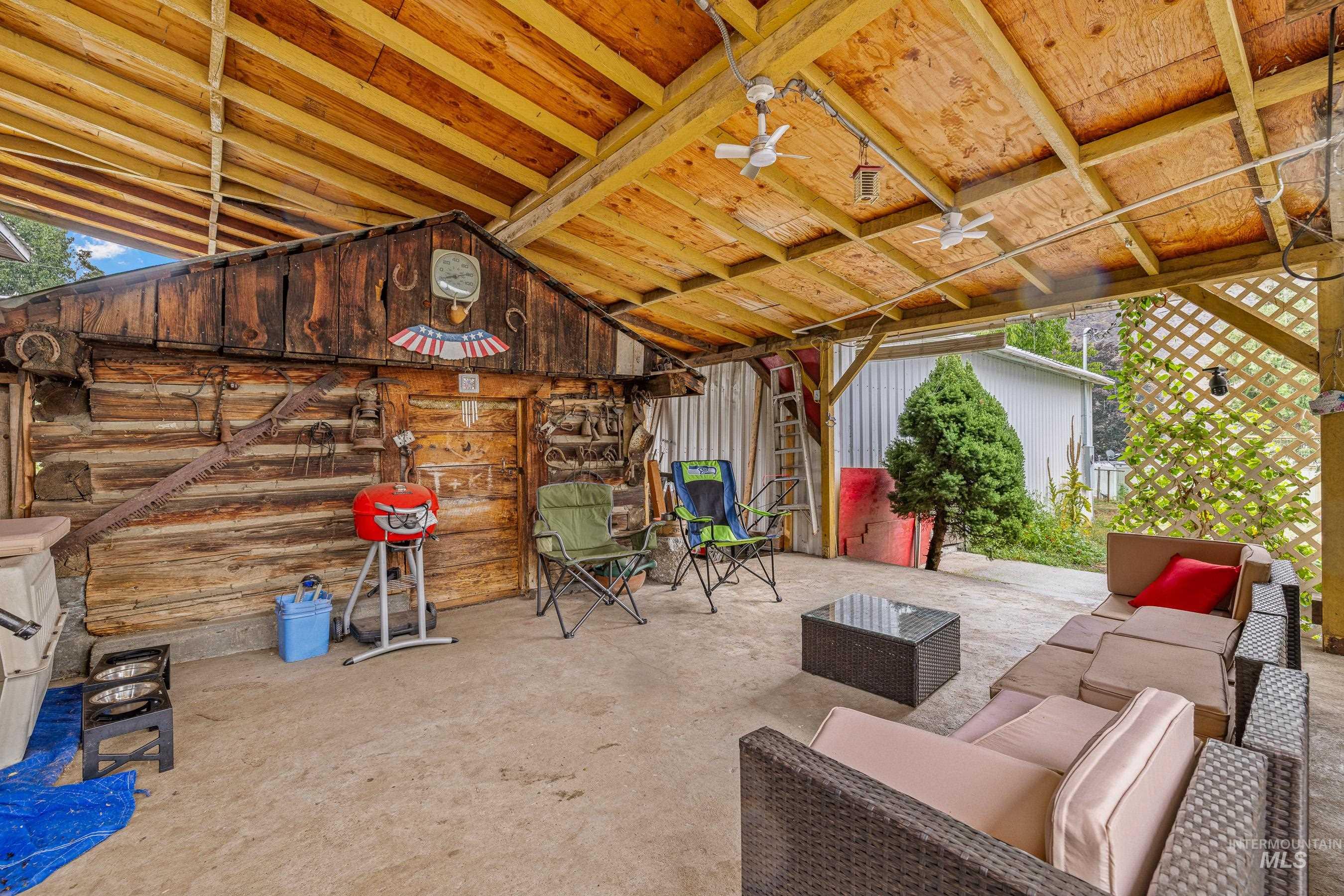620 South Main Street Riggins, ID 83549 - Photo 17 of 23 Covered patio with a concrete surface, exposed wood ceiling, and multiple ceiling fans