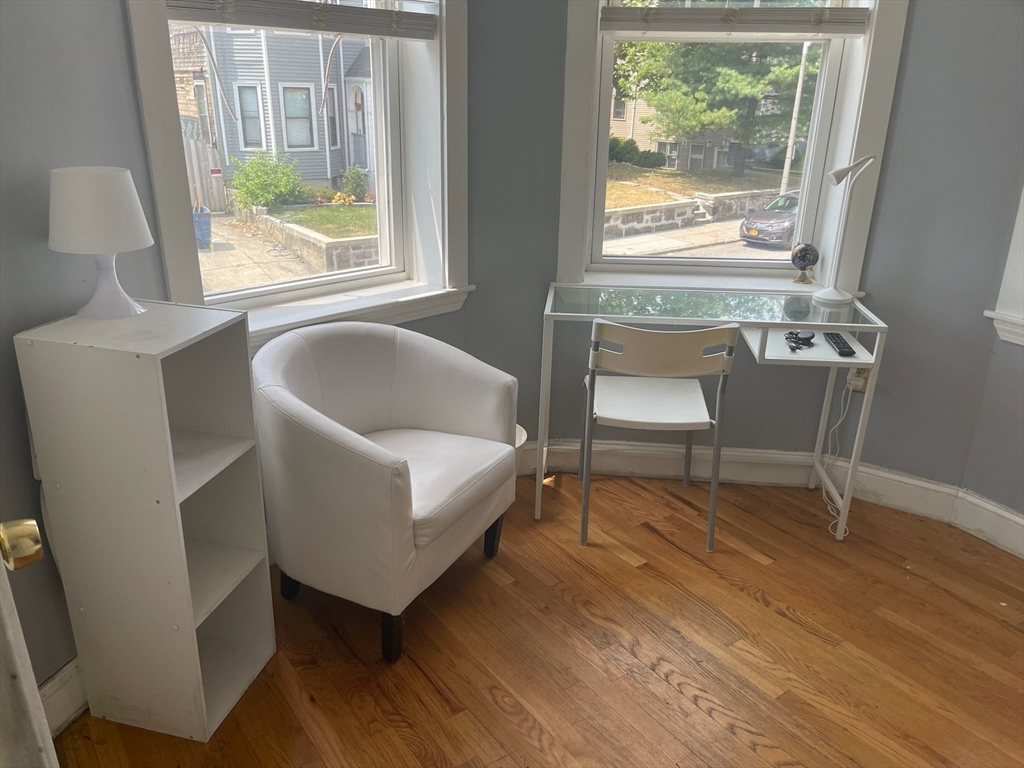 102 Moreland Street Boston, MA 02119 - Photo 11 of 31 a living room with a couch and a table