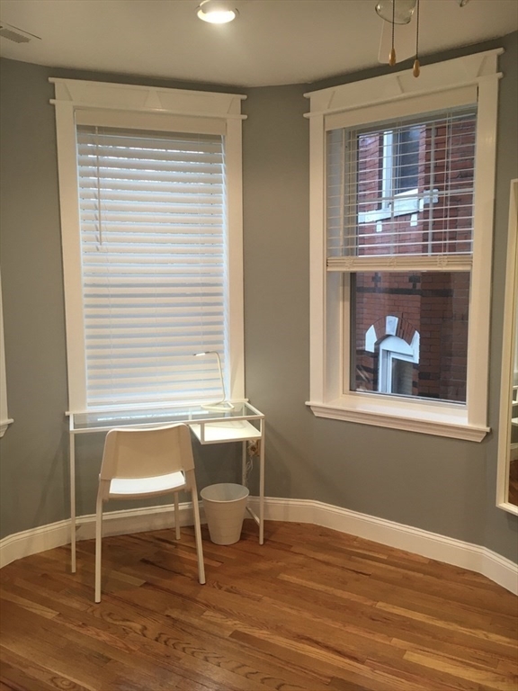 102 Moreland Street Boston, MA 02119 - Photo 13 of 31 a view of a livingroom with wooden floor and a window