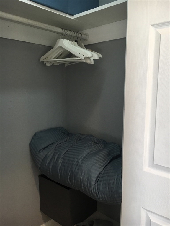 102 Moreland Street Boston, MA 02119 - Photo 17 of 31 a bed sitting in a bedroom next to a window