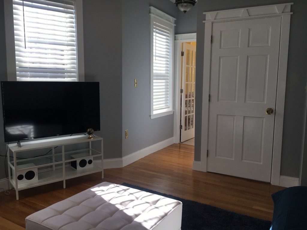 102 Moreland Street Boston, MA 02119 - Photo 20 of 31 a living room with furniture and a flat screen tv