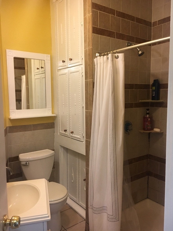 102 Moreland Street Boston, MA 02119 - Photo 21 of 31 a bathroom with a toilet and a shower