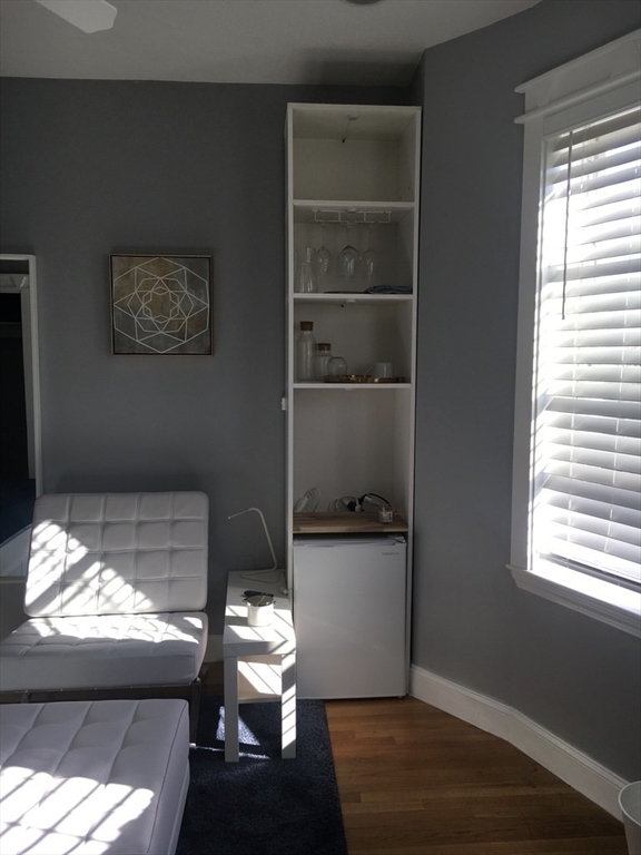 102 Moreland Street Boston, MA 02119 - Photo 30 of 31 a room with a window and wooden floor