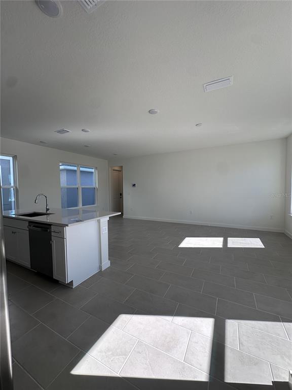 2059 Iorio Street St. Cloud, FL 34771 - Photo 20 of 61 a living room with a couch and a coffee table