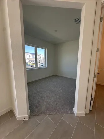 a kitchen with granite countertop white cabinets and stainless steel appliances