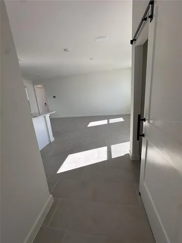 a view of kitchen with furniture and refrigerator