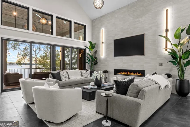 a living room with furniture and a floor to ceiling window