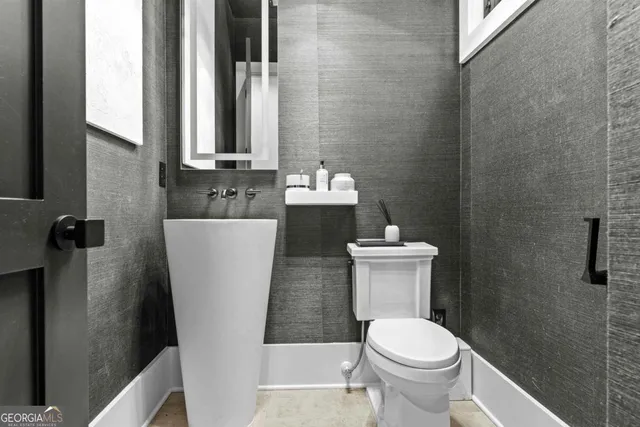 a living room with furniture large window and wooden floor